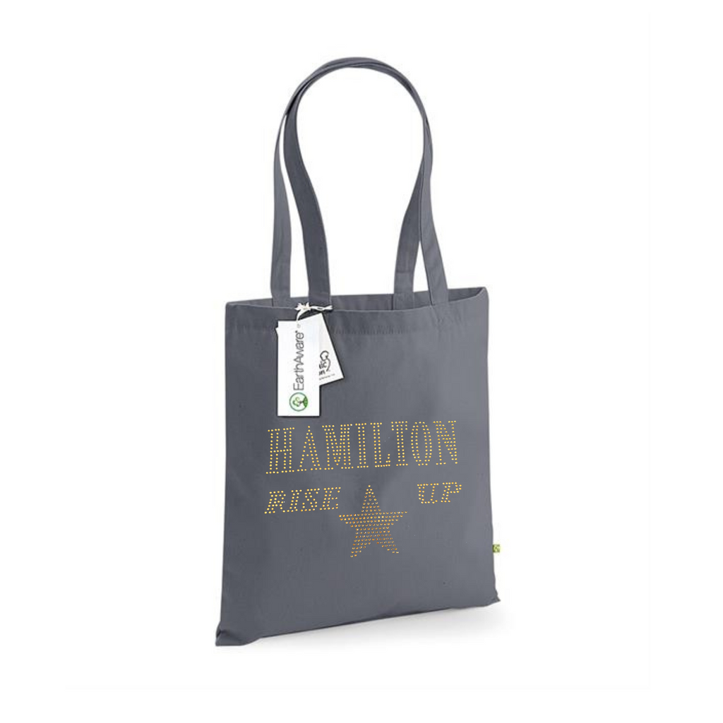 Dark grey cotton tote bag, on the front is a gold sparkling "Hamilton Rose up" lettering with a gold star set just underneath.
design is made up of sparkling rhinestones that catch the light beautifully