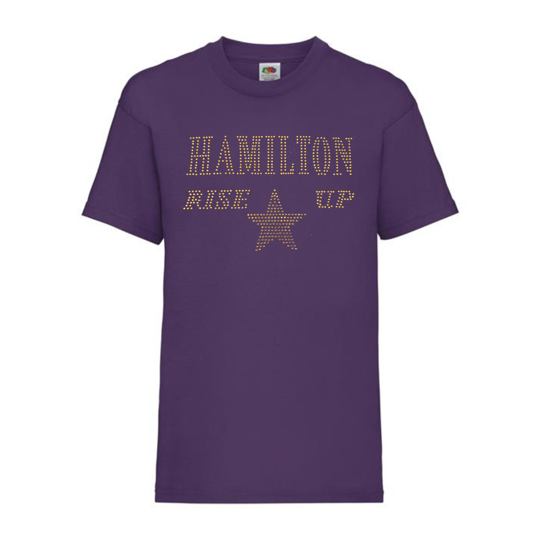 Purple cotton short sleeve t shirt with HAMILTON AND RISE UP spelt out and a gold star underneath.
The design is made up of gold rhinestones that sparkle in the light beautifully.
