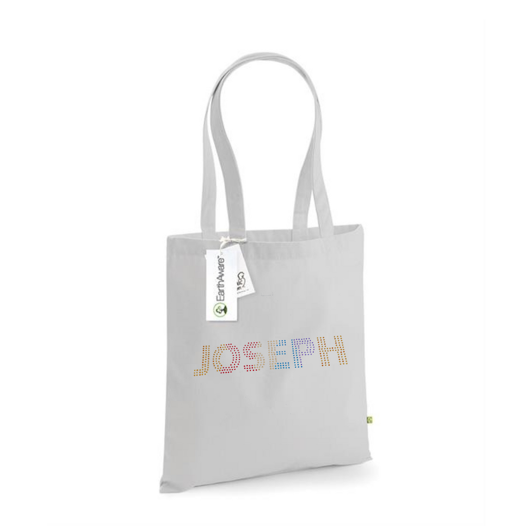 Light grey cotton tote bag with long handles, on the front is the word Joseph in block capitals, this word gradually changes from gold to red to champagne to blue to purple back to gold
Design is made up of hot fix rhinestones that are heat pressed to produce a design that sparkles and catches the light beautifully
