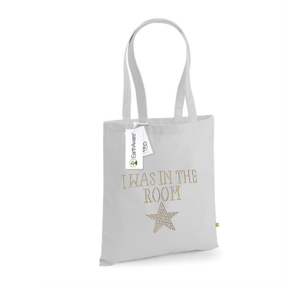 Light grey cotton tote bag, on the front is a gold sparkling "I was in the room" lettering with a gold star set just underneath.
design is made up of sparkling rhinestones that catch the light beautifully