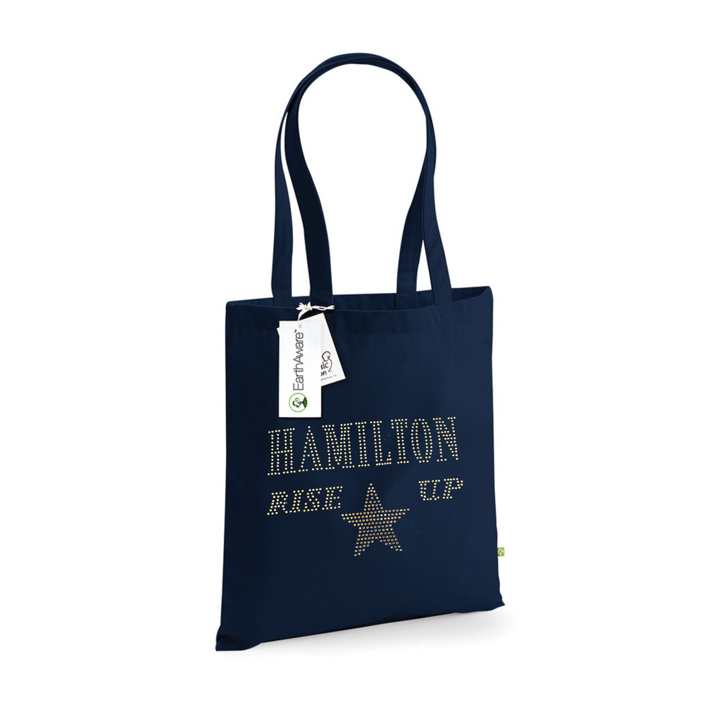 Navy cotton tote bag, on the front is a gold sparkling "Hamilton Rose up" lettering with a gold star set just underneath.
design is made up of sparkling rhinestones that catch the light beautifully