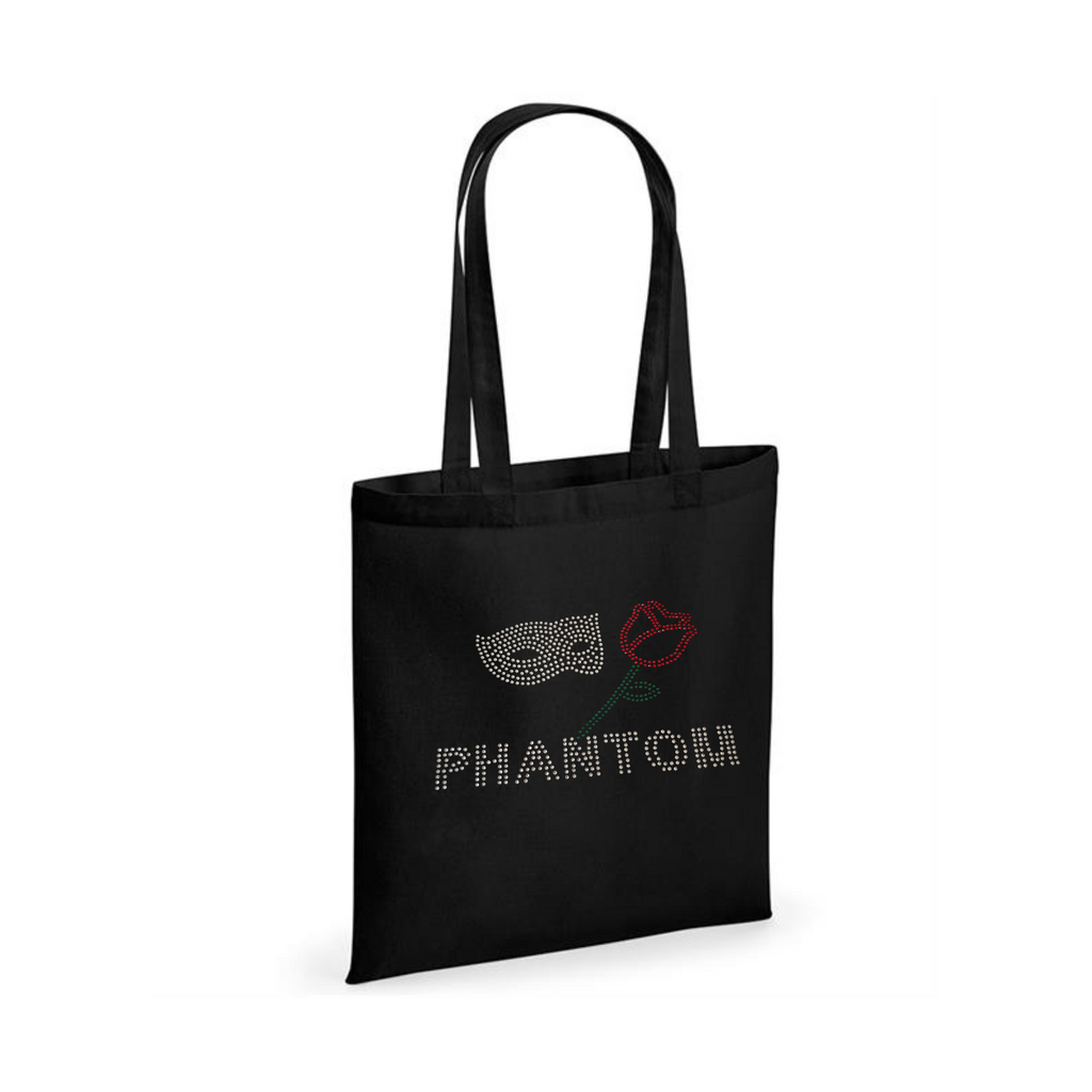 BLACK COTTON TOTE BAG WITH LONG HANDLES WITH PHANTOM LETTERING, ABOVE THIS A SILVER MASK AND RED ROSE WITH GREEN STEM AND LEAF.
THE DESIGN IS MADE UP OF HOT FIX RHINESTONES THAT HEAT PRESSED AND CATCH THE LIGHT BEAUTIFULLY